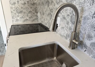 ADU sink with very pretty floral designed backsplash Custom Home with Lockoff ADU in Buena Vista by S&T Construction 1B089E04 FCA5 4B27 A42D 55BB0183F1CD 1 102 o