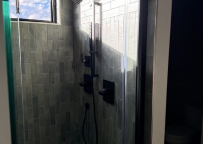Dual shower heads in tiled shower stall in Custom Home with Lockoff ADU in Buena Vista by S&T Construction 87B96D2C 2AB9 4C84 A3BD F755A44BADF7 1 105 c