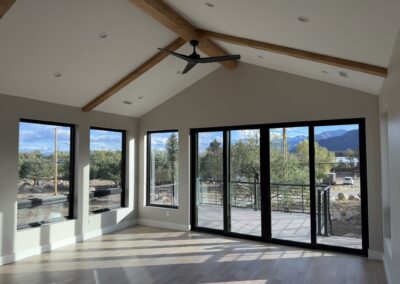 walls of windows in the grand room with french doors to back patio Custom Home with Lockoff ADU in Buena Vista by S&T Construction 2F4DF981 56E9 4CDF A9BE 06522035E416 1 102 o